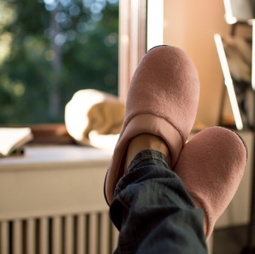 A woman relaxing in her slippers after Air Conditioning Installation in Bloomington IL