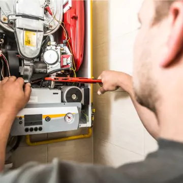 Repair tech fixing a furnace unit